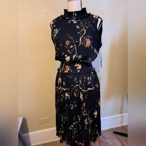 Nanette Lepore sleeveless dress. Dark background floral. Pleats.